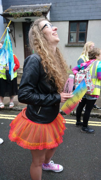 A Safe Harbour member at Pride with a sign saying 'God thinks you are fabulous'